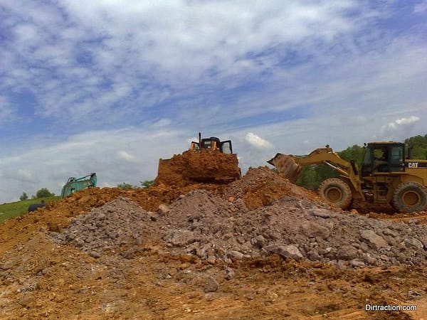 a team of dozer working concurrently, with Tom operating the Cat